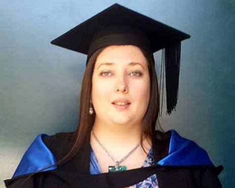 Melinda in her graduation gown for her Masters of Biotechnology